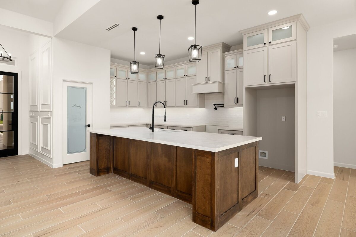 Custom kitchen with wood island and pendant lighting